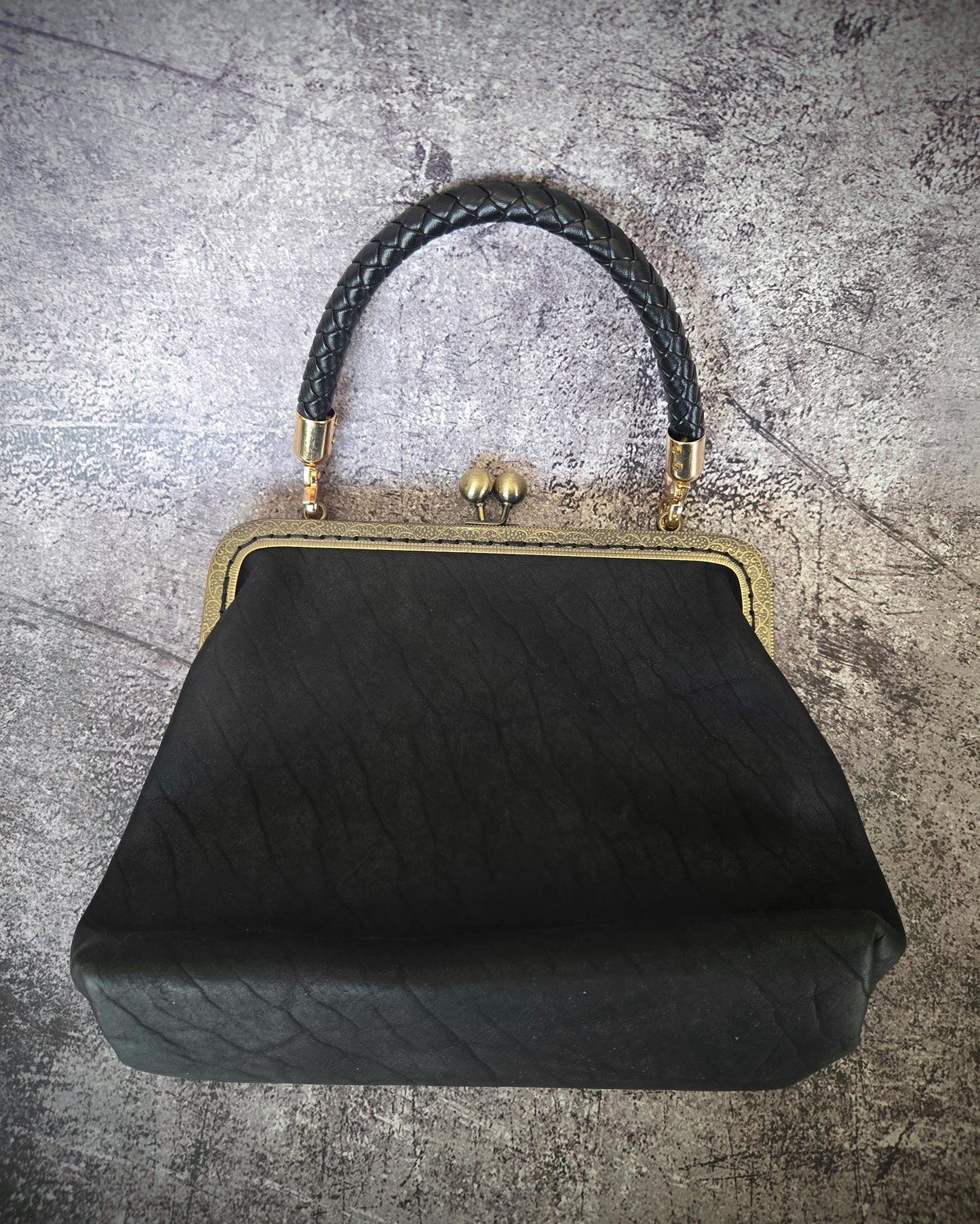 Small Black Leather Handbag with Ball Clasp Closure