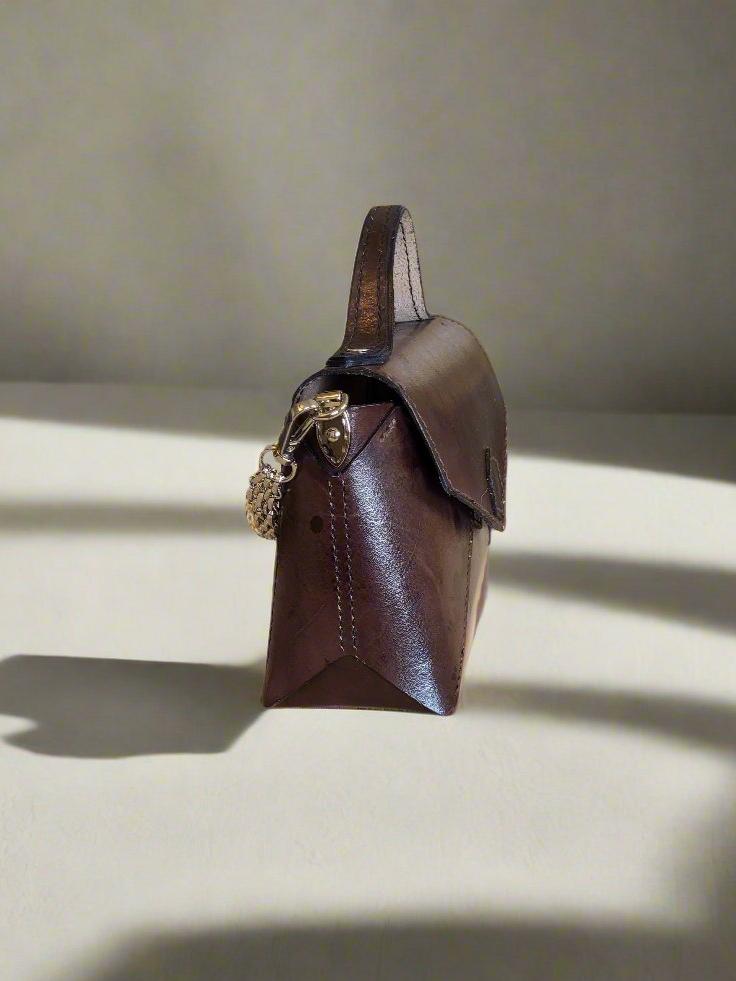 small brown leather handbag with optional gold chain attached