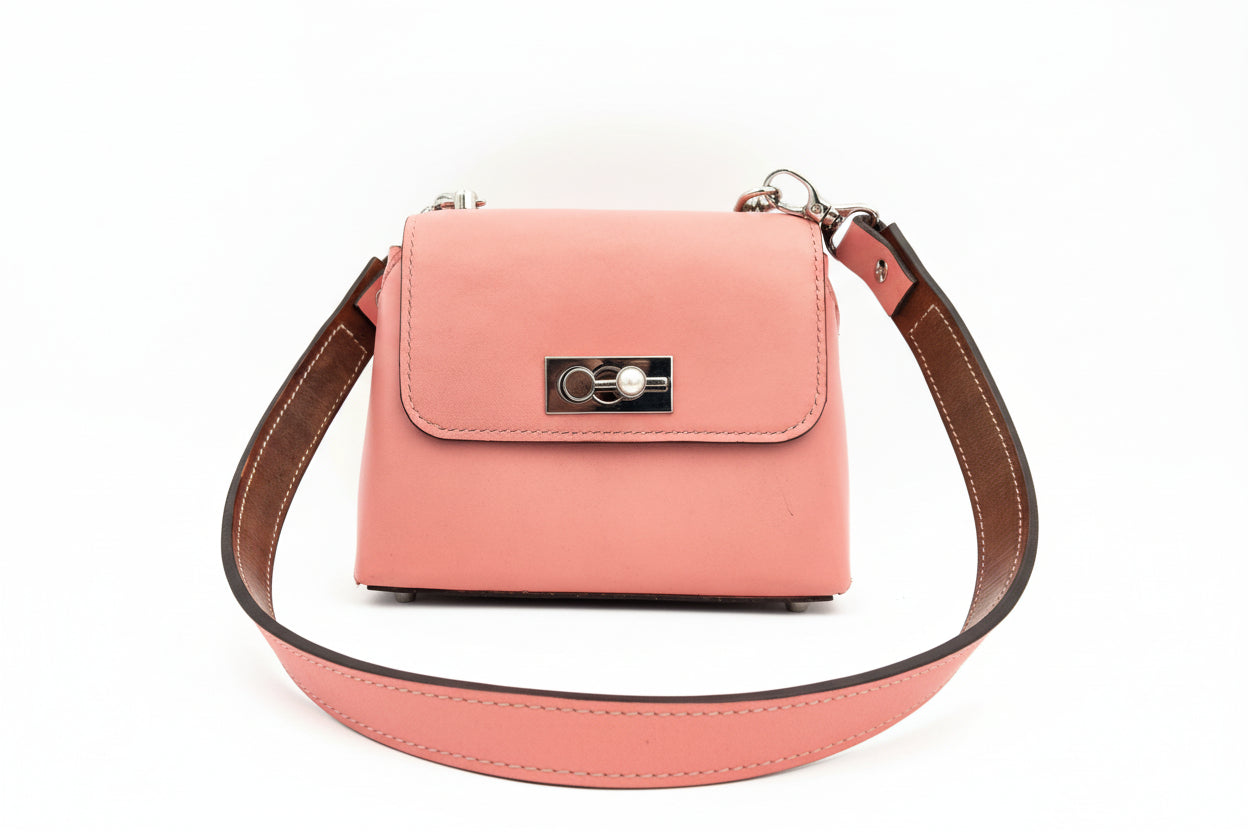 Pink handbag with a silver pearl clasp on a white background