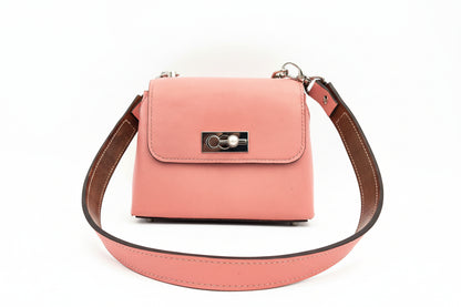 Pink handbag with a silver pearl clasp on a white background