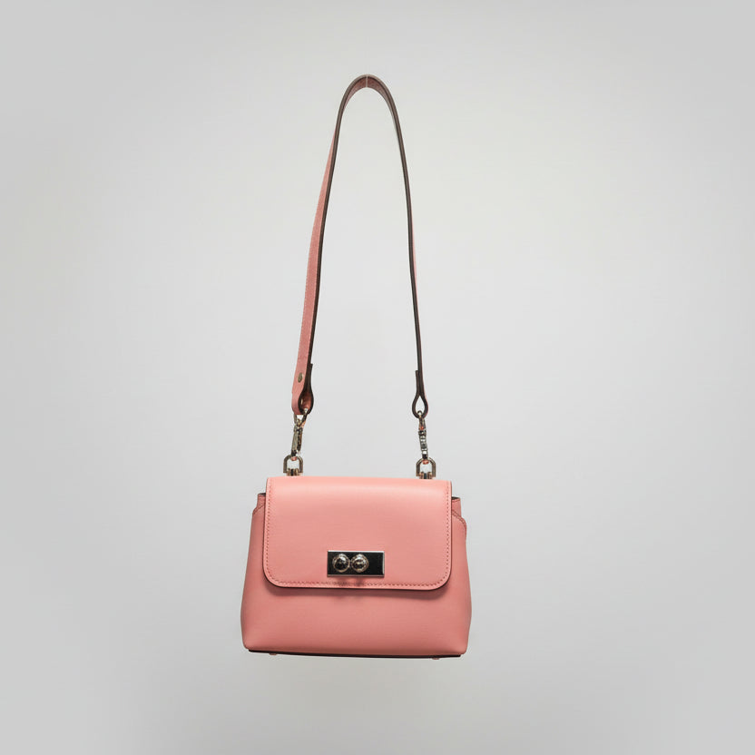 Pink handbag with a detachable shoulder strap on a light gray background.
