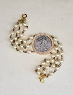 Handmade Three Strand Pearl Bracelet featuring a Bold Liberty Coin Detail