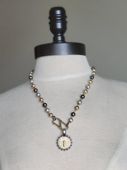 Matte Gold Queen Bee Coin in antique silver bezel on 22 inch tri-color pearl necklace.