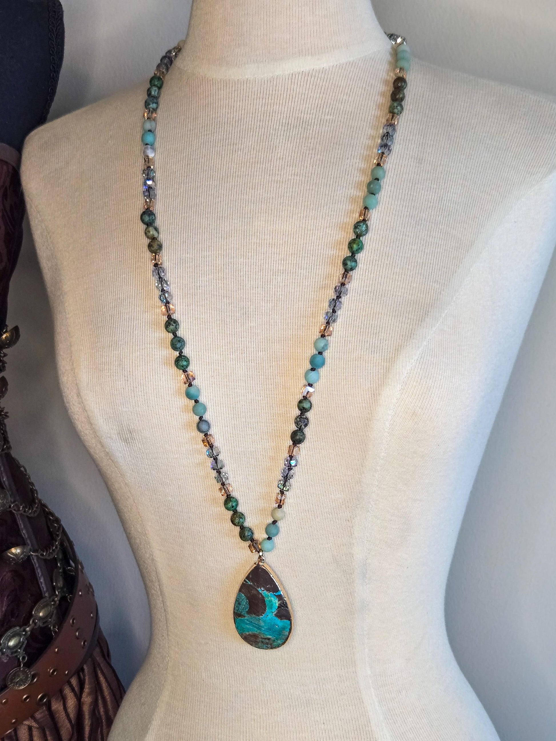 A 32&quot; necklace with large tear drop pendant that is African Turquoise. Necklace is hand knotted with 6mm African Turquoise beads and crystals.