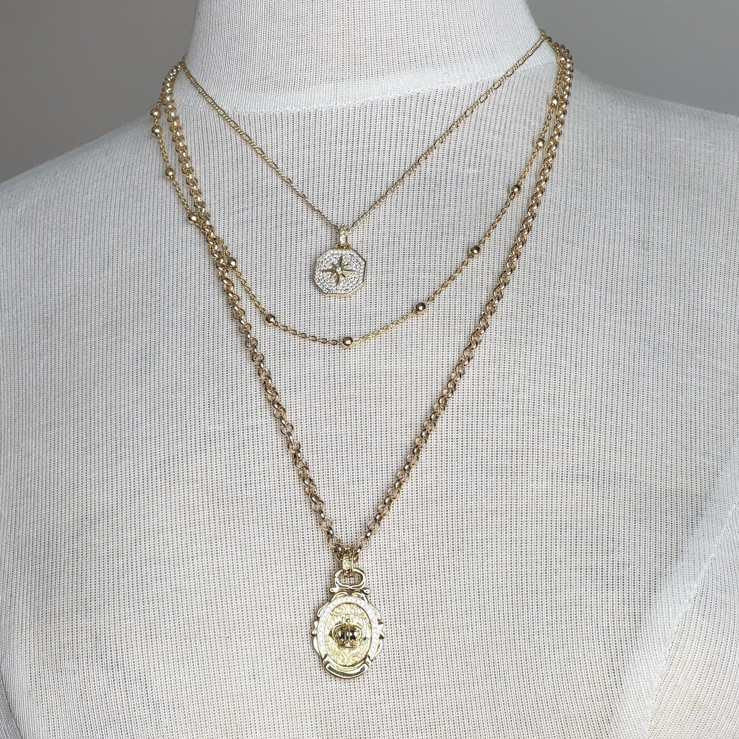 Celestial Royalty, Layered Necklace – Pave Starburst, Satellite Chain & Crown Medallion in Gold Tone Finish