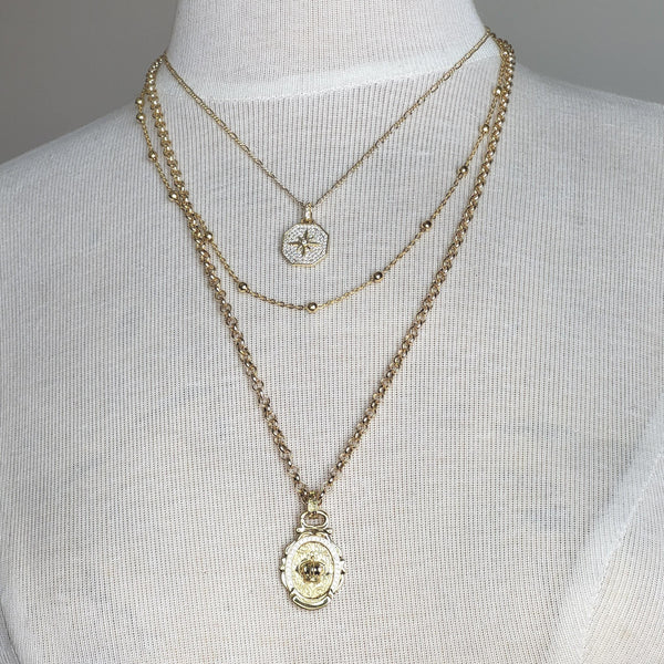 Celestial Royalty, Layered Necklace – Pave Starburst, Satellite Chain & Crown Medallion in Gold Tone Finish